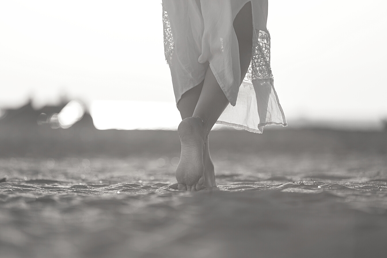 Girl walking on hotel beach.