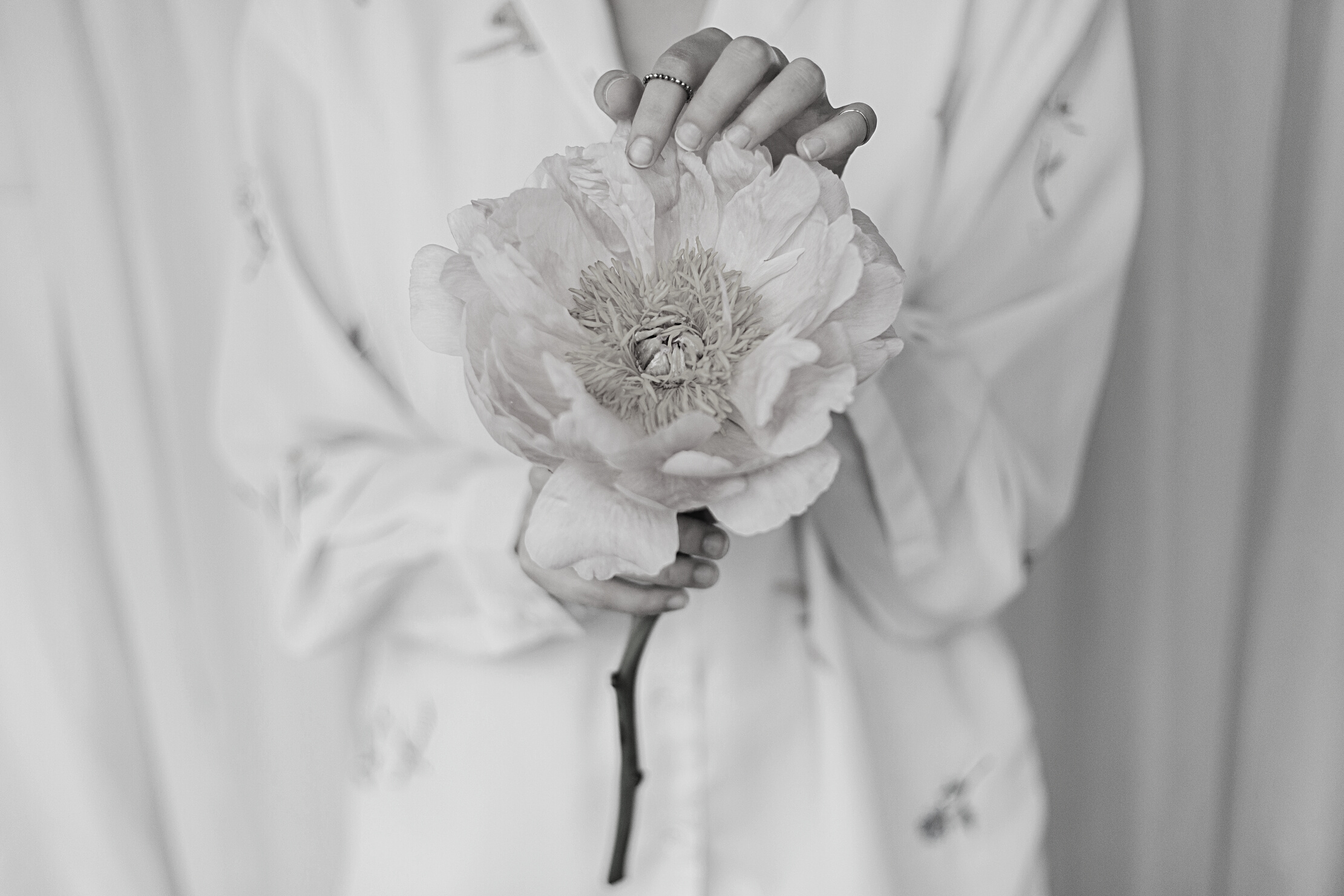 Sensual beautiful woman with pink peony in hands. Tender soft image. Spring aesthetics
